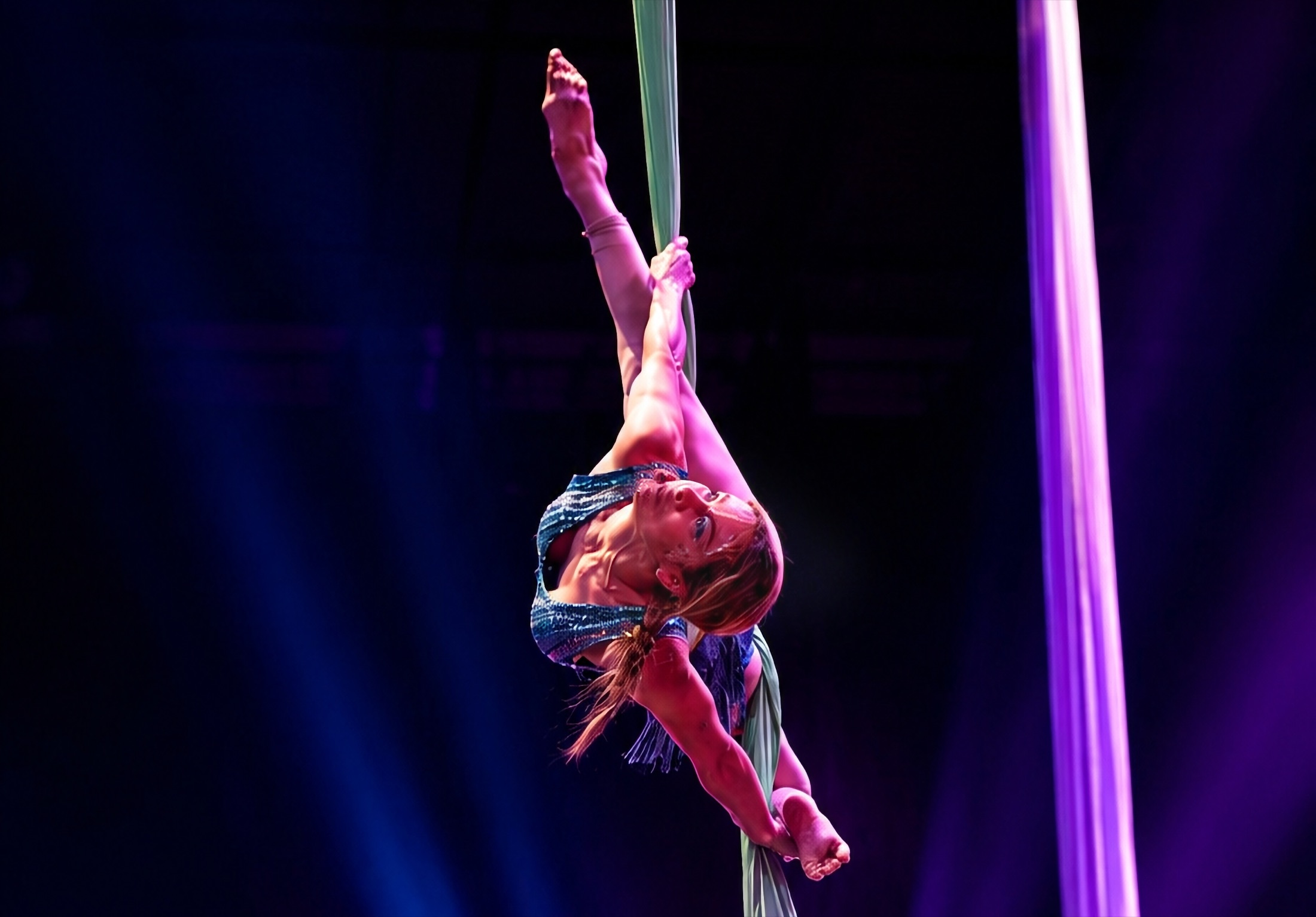 Young student training on aerial silks